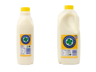Two plastic milk bottles with yellow caps and yellow labels.